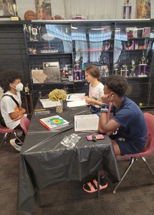 group of grind out students sitting at a table studying