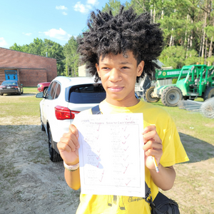 Photo of Grind Out student holding a grade A test for Algebra